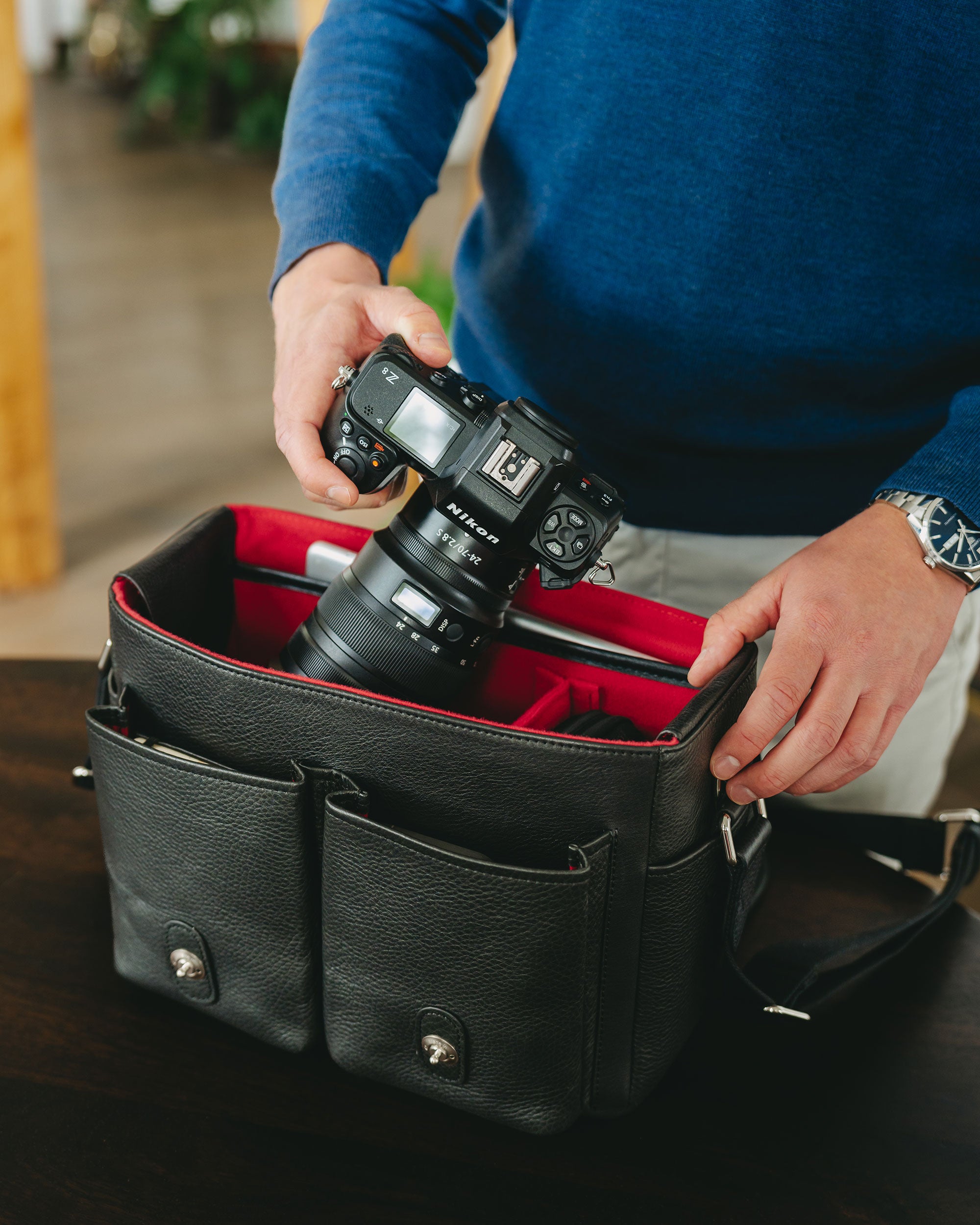 Portrait of a Little William holding a Nikon camera